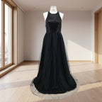 Black evening gown with sequined top on a white background