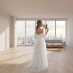 Woman in a white wedding dress holding flowers in a softly lit room.