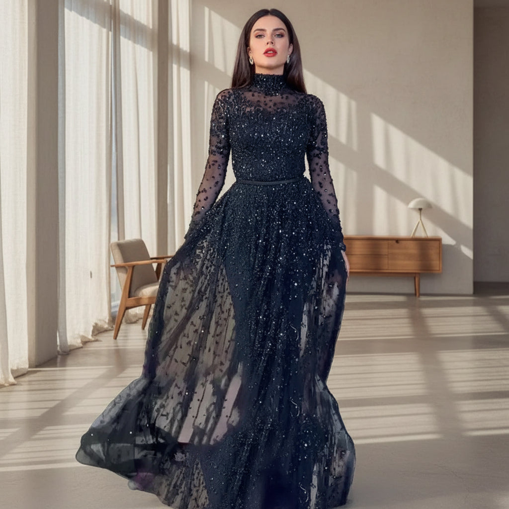 Black sheer evening gown with long sleeves and a flowing skirt on a neutral background