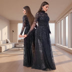 Woman wearing a black sequin dress against a neutral background