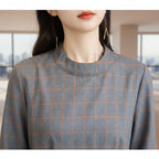 Close-up of a gray and orange checkered fabric on a mannequin