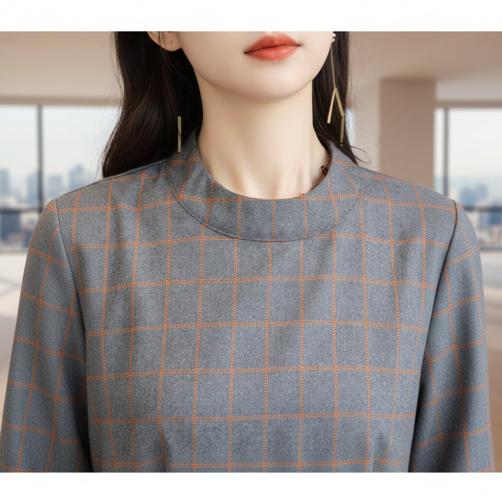 Close-up of a gray and orange checkered fabric on a mannequin