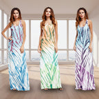 Three women wearing tie-dye maxi dresses on a white background