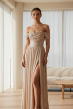 Elegant off-shoulder gown with a high slit on a gray background