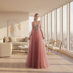 Woman wearing a pink evening gown with a beaded top in a bright room.