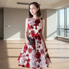 Woman wearing a red and white floral dress against a light background